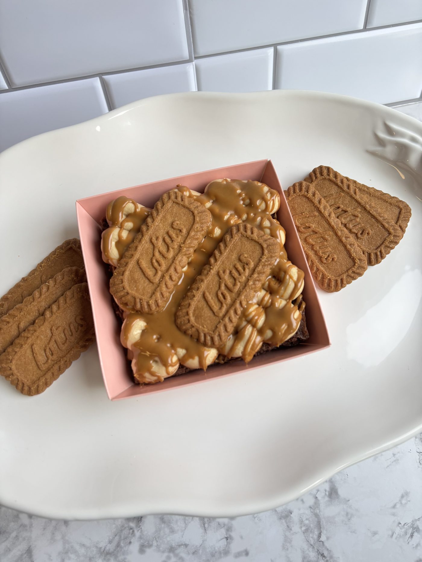 Fudgy brownie topped with Biscoff cookies and caramel drizzle